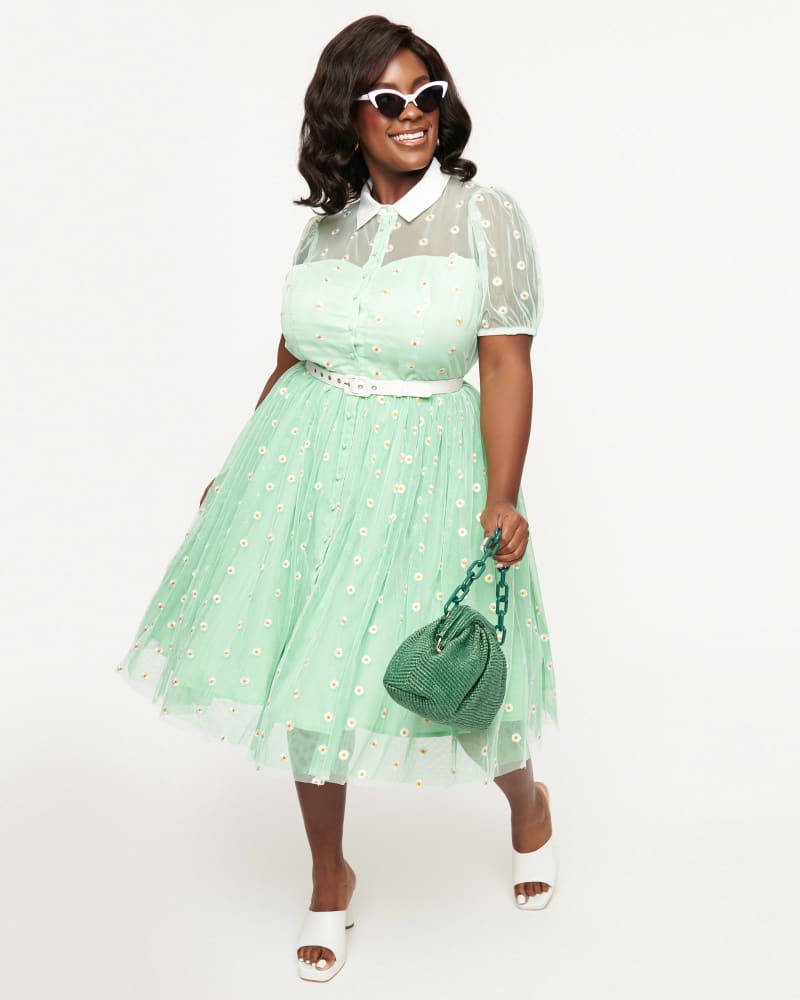 Front of a model wearing a size 4X Unique Vintage 1950s Green & White Daisy Print Hollie Swing Dress in Green & White Daisy Print by Unique Vintage. | dia_product_style_image_id:349158